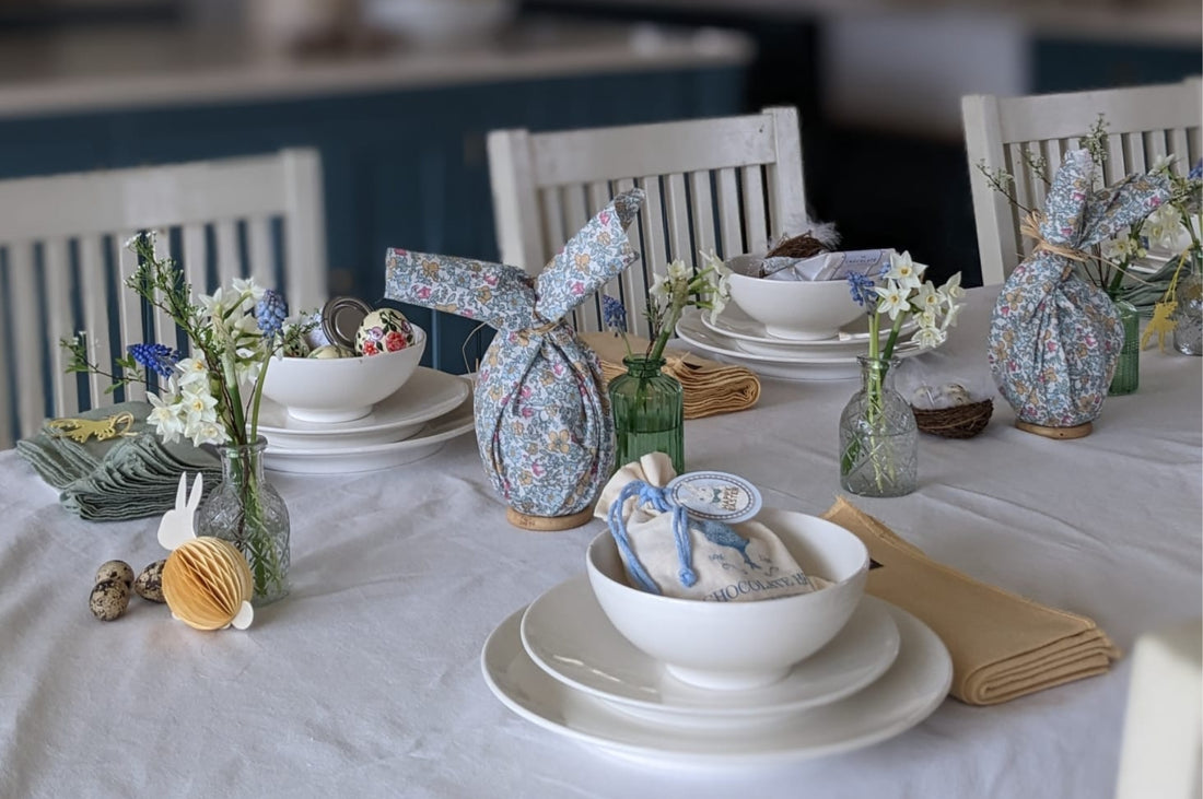 Pod & Pip's home made Easter Bunnys, displayed on a table alongside easter eggs and seasonal flowers.